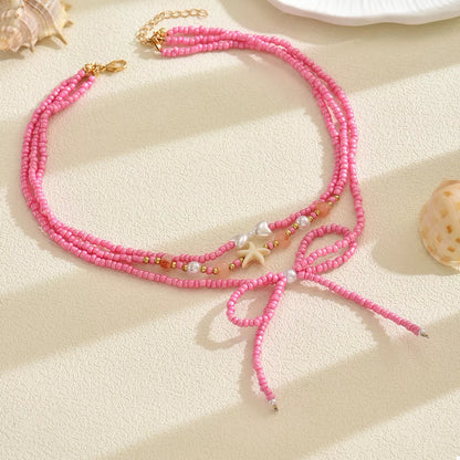 Beaded Three-Layered Necklace with Bow and Starfish Charms