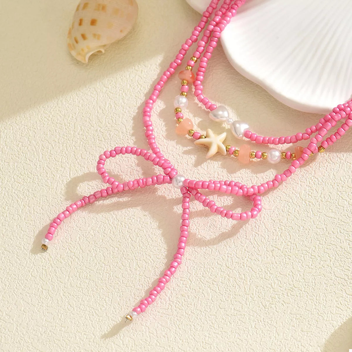 Beaded Three-Layered Necklace with Bow and Starfish Charms